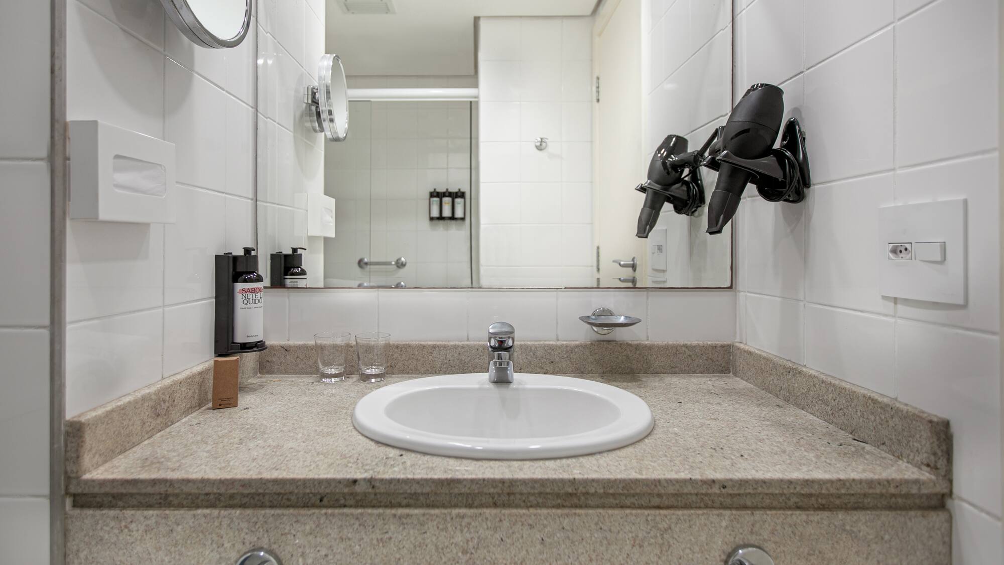 a bathroom sink with a mirror and a mirror