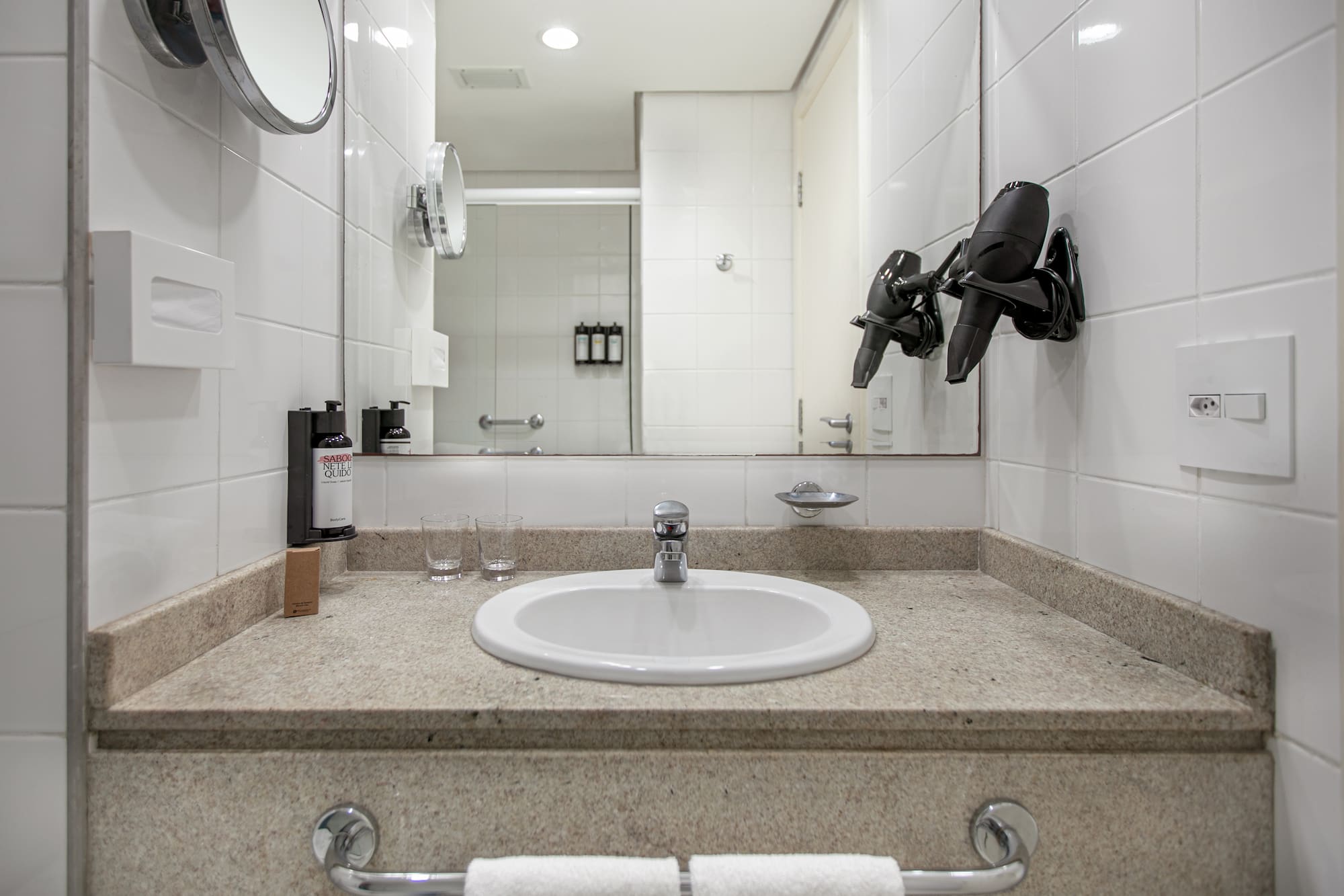 a bathroom sink with a mirror and a mirror