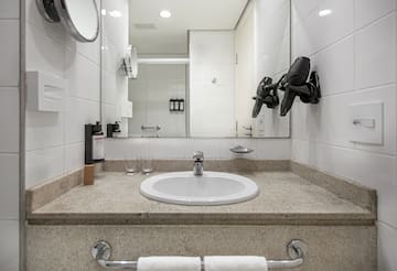 a bathroom sink with a mirror and a mirror