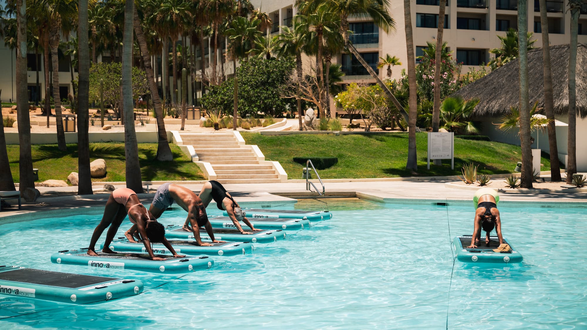 a group of people doing yoga in a pool