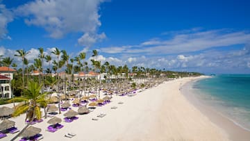 a beach with umbrellas and chairs