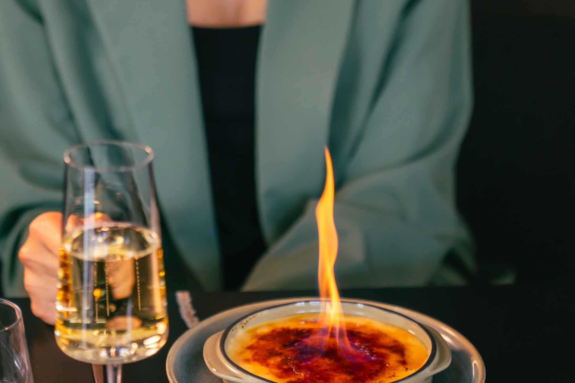 a person holding a glass of wine and a plate with food on it