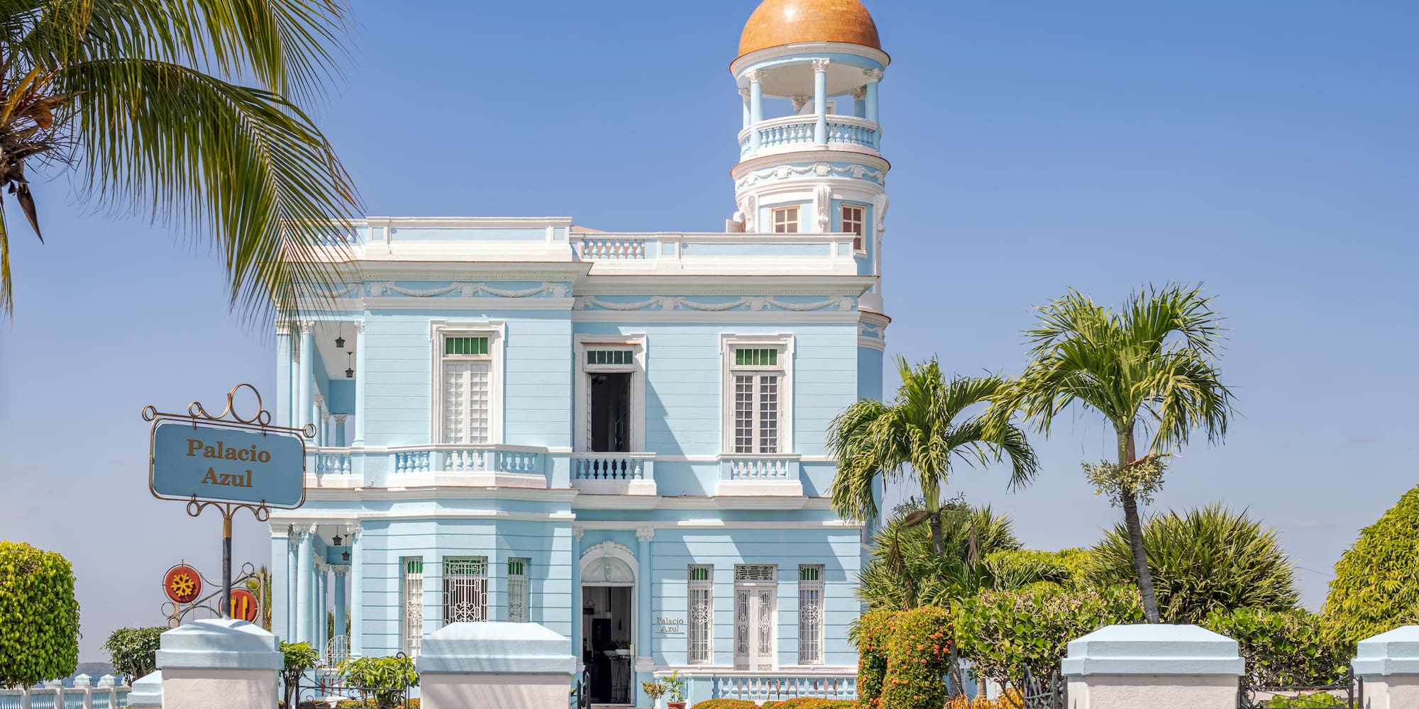 a blue and white building with a gold dome on top