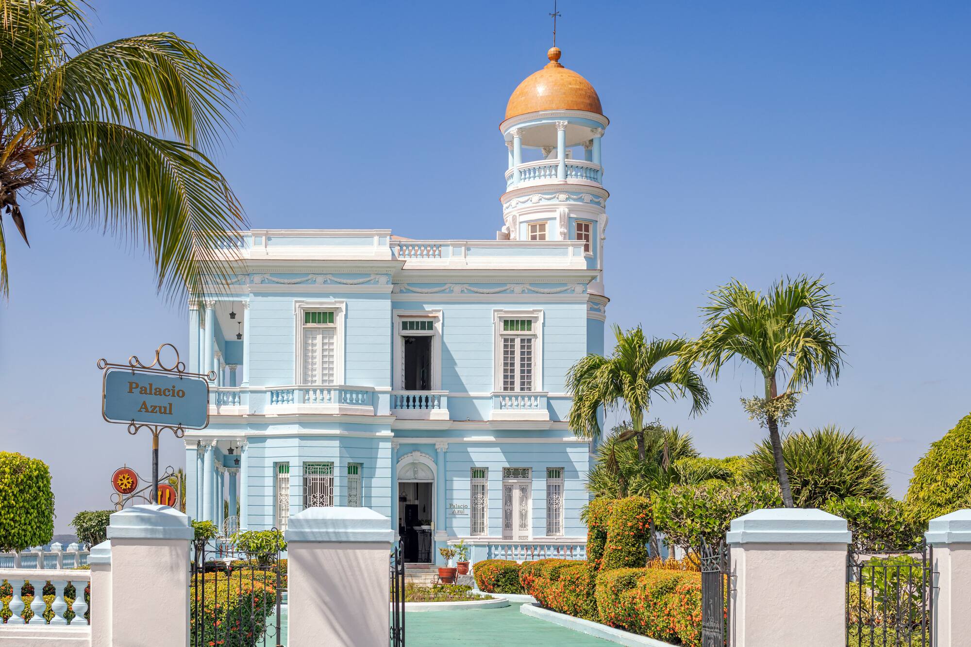 a blue and white building with a gold dome on top