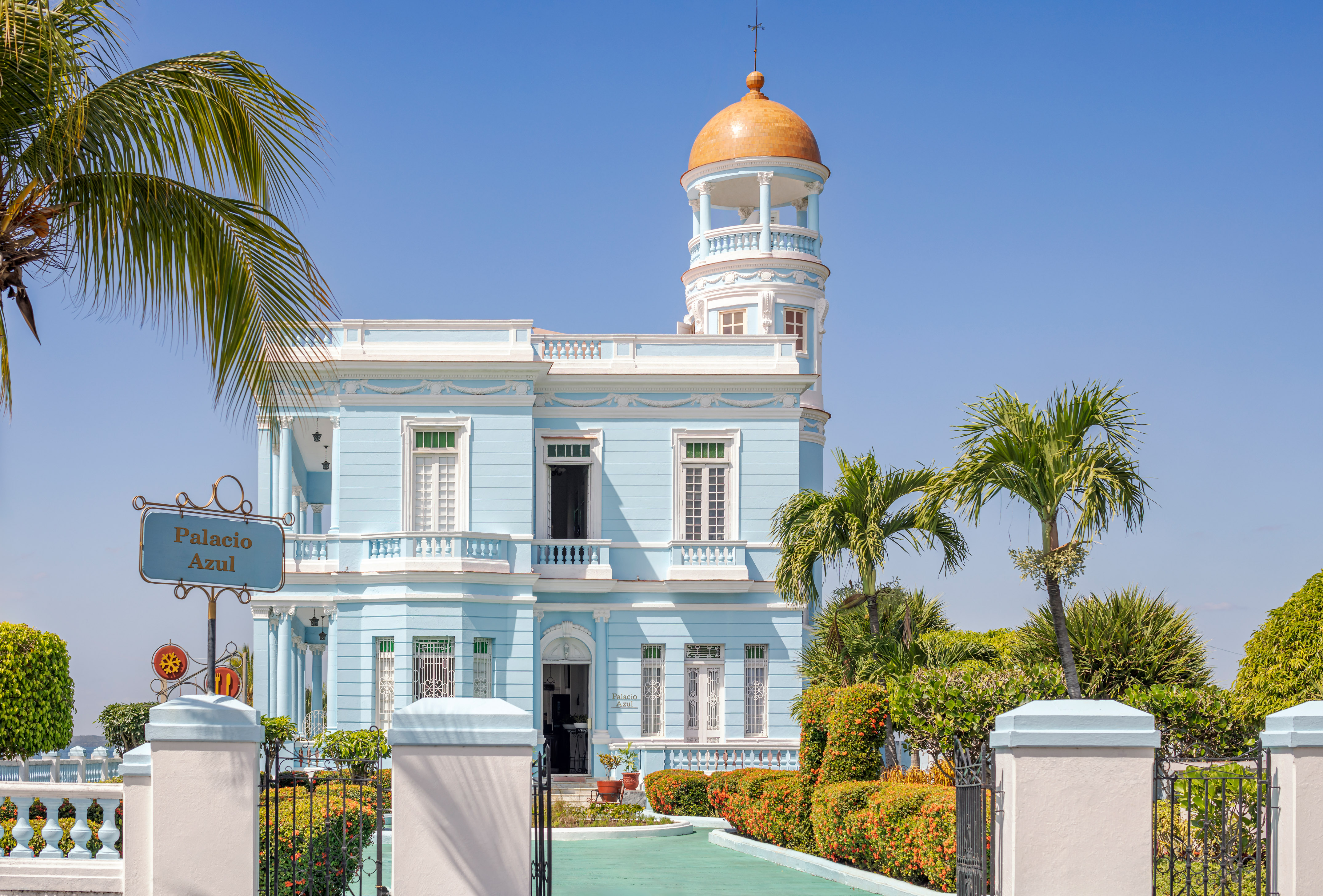 a blue and white building with a gold dome on top