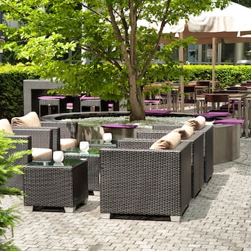 a patio area with tables and chairs