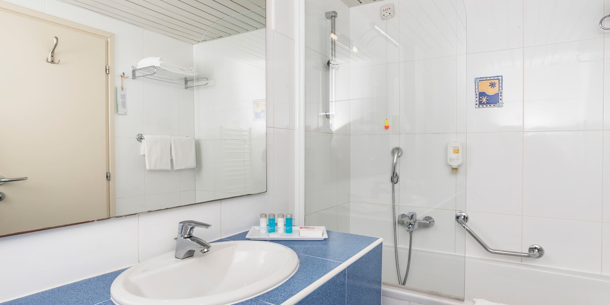 a bathroom with a shower and sink