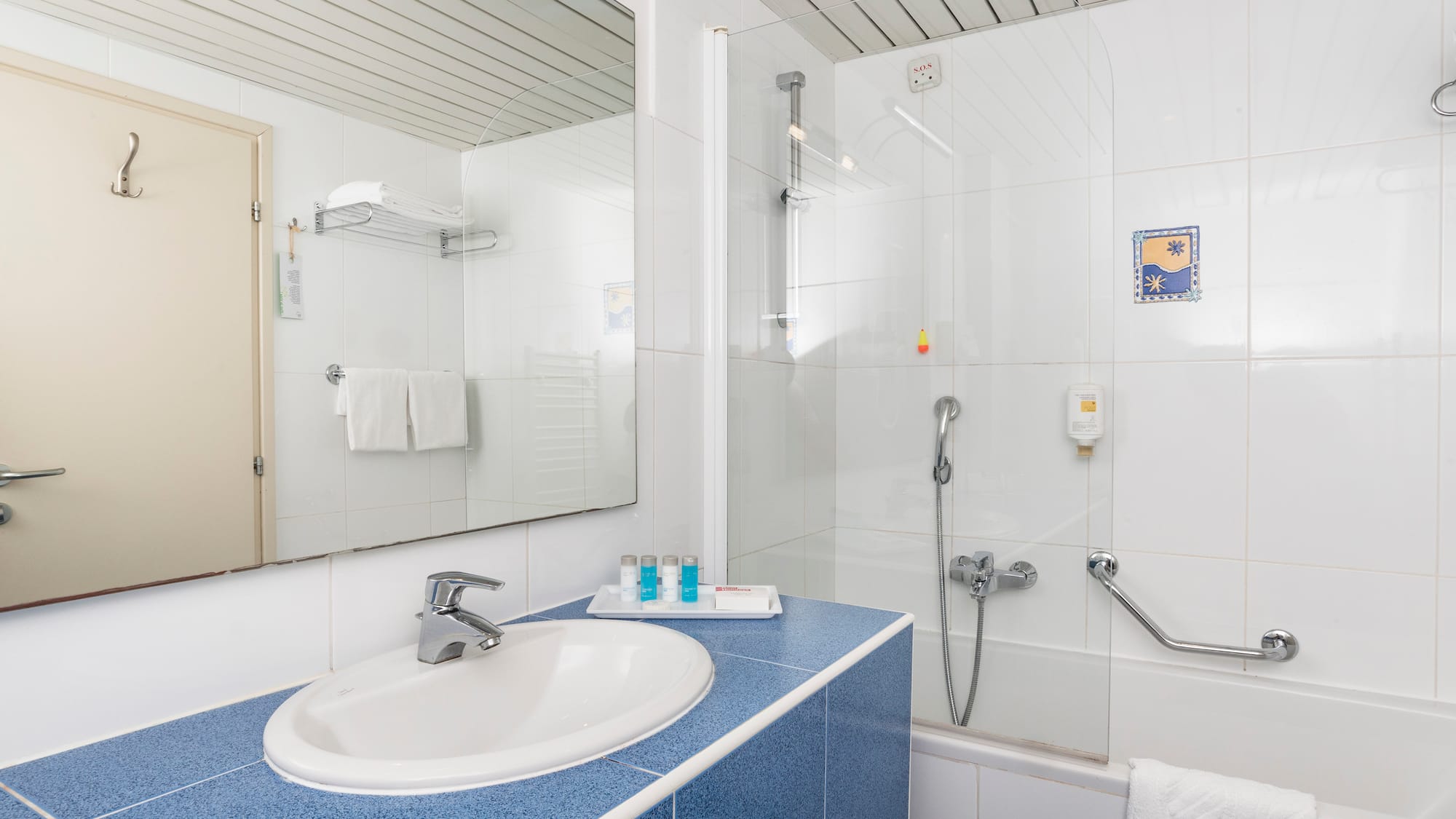 a bathroom with a shower and sink
