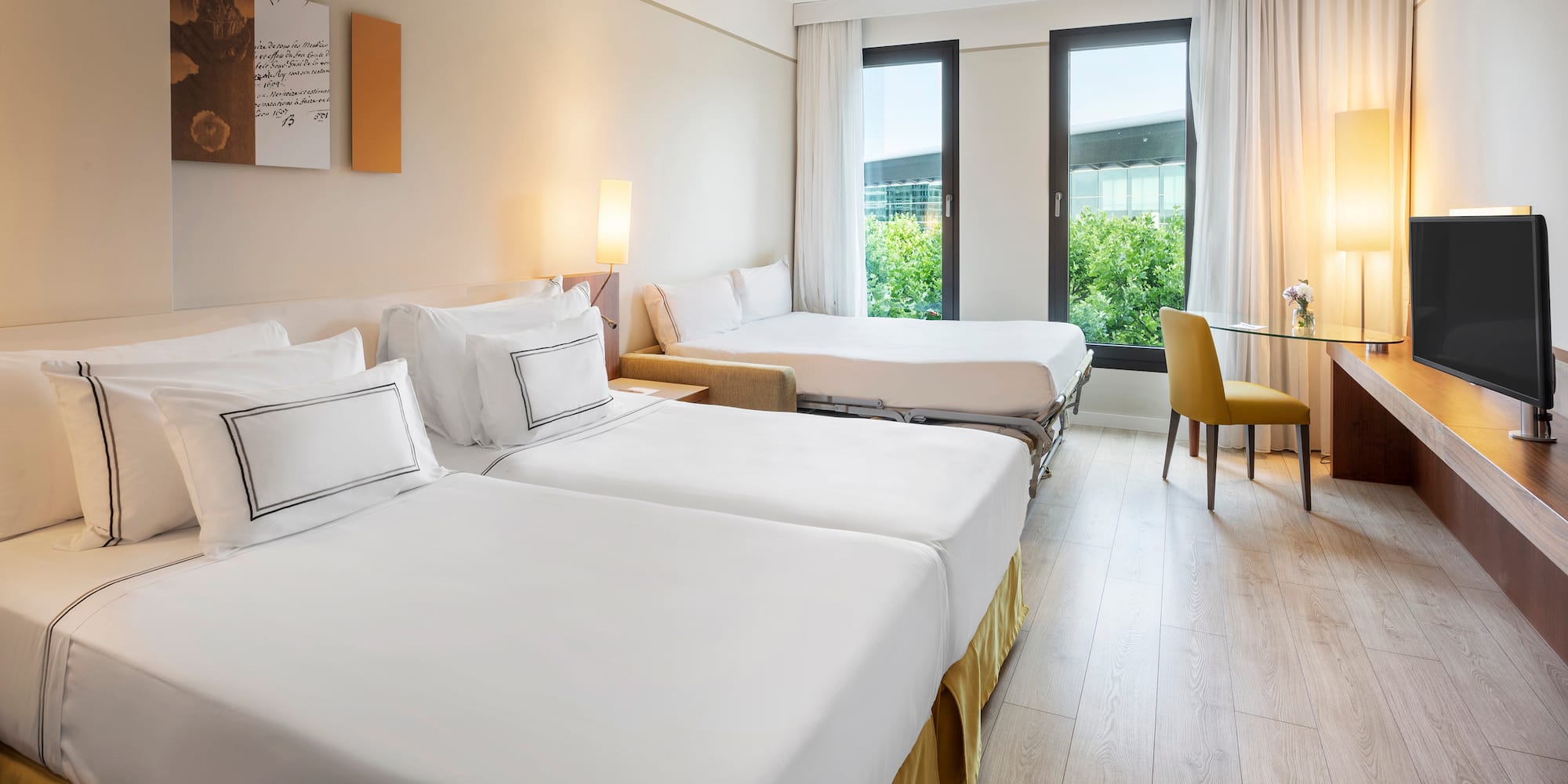 a room with two beds and a table