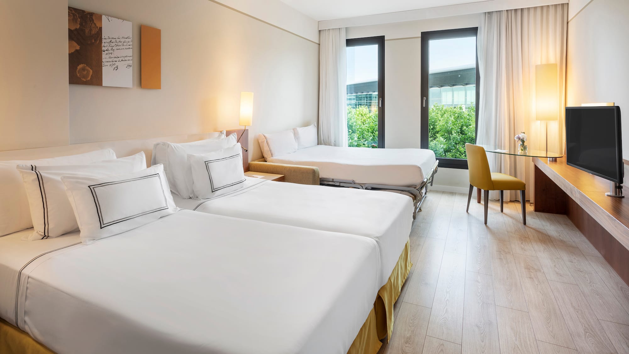 a room with two beds and a table