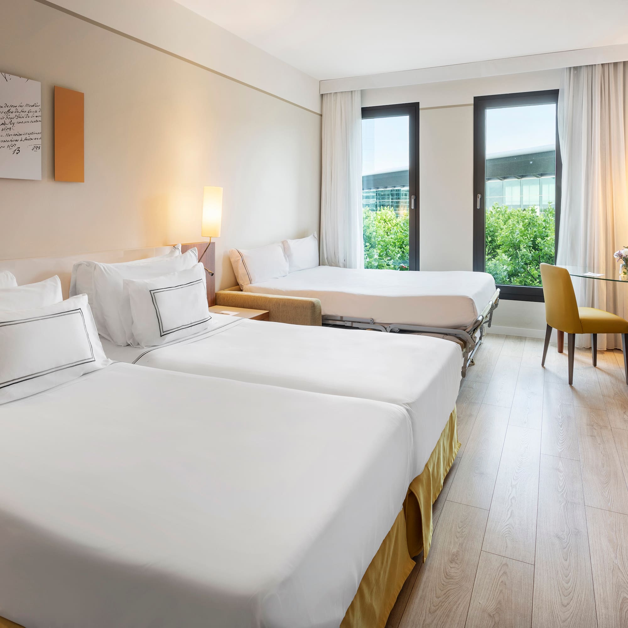 a room with two beds and a table