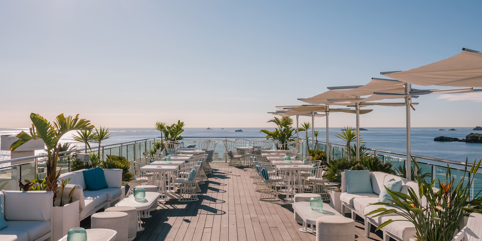 a white bar with blue pillows and chairs