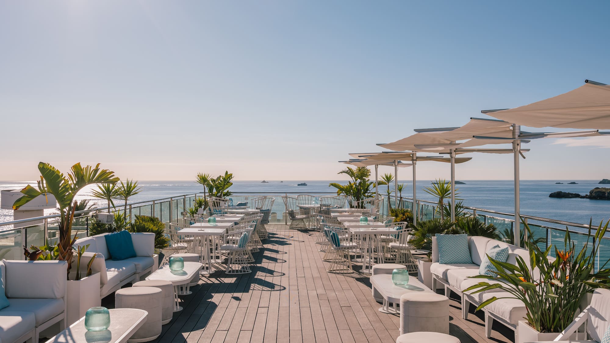 a white bar with blue pillows and chairs