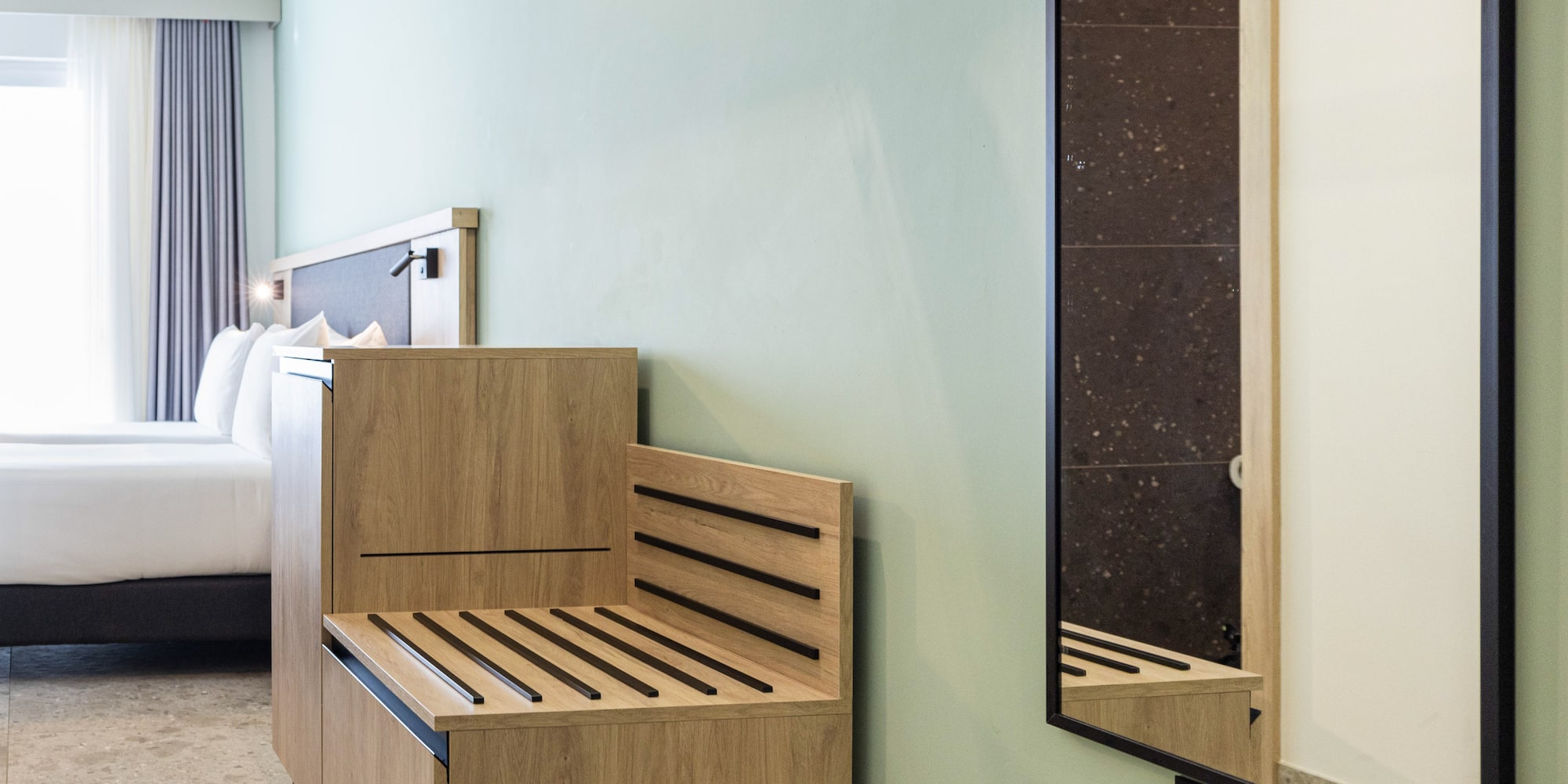 a room with a bench and a mirror