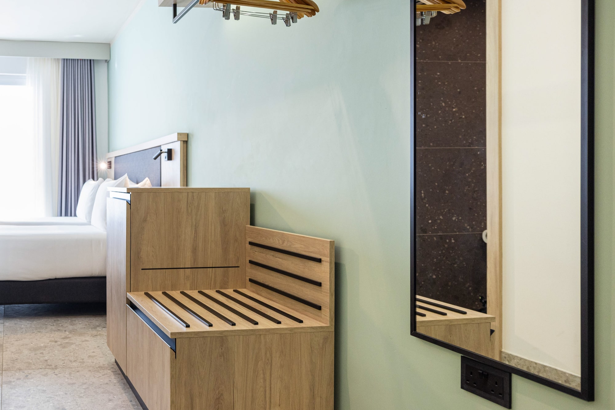 a room with a bench and a mirror