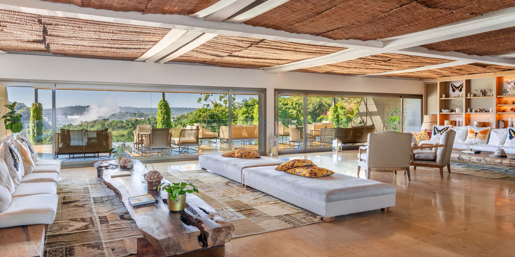 a large living room with a large table and chairs