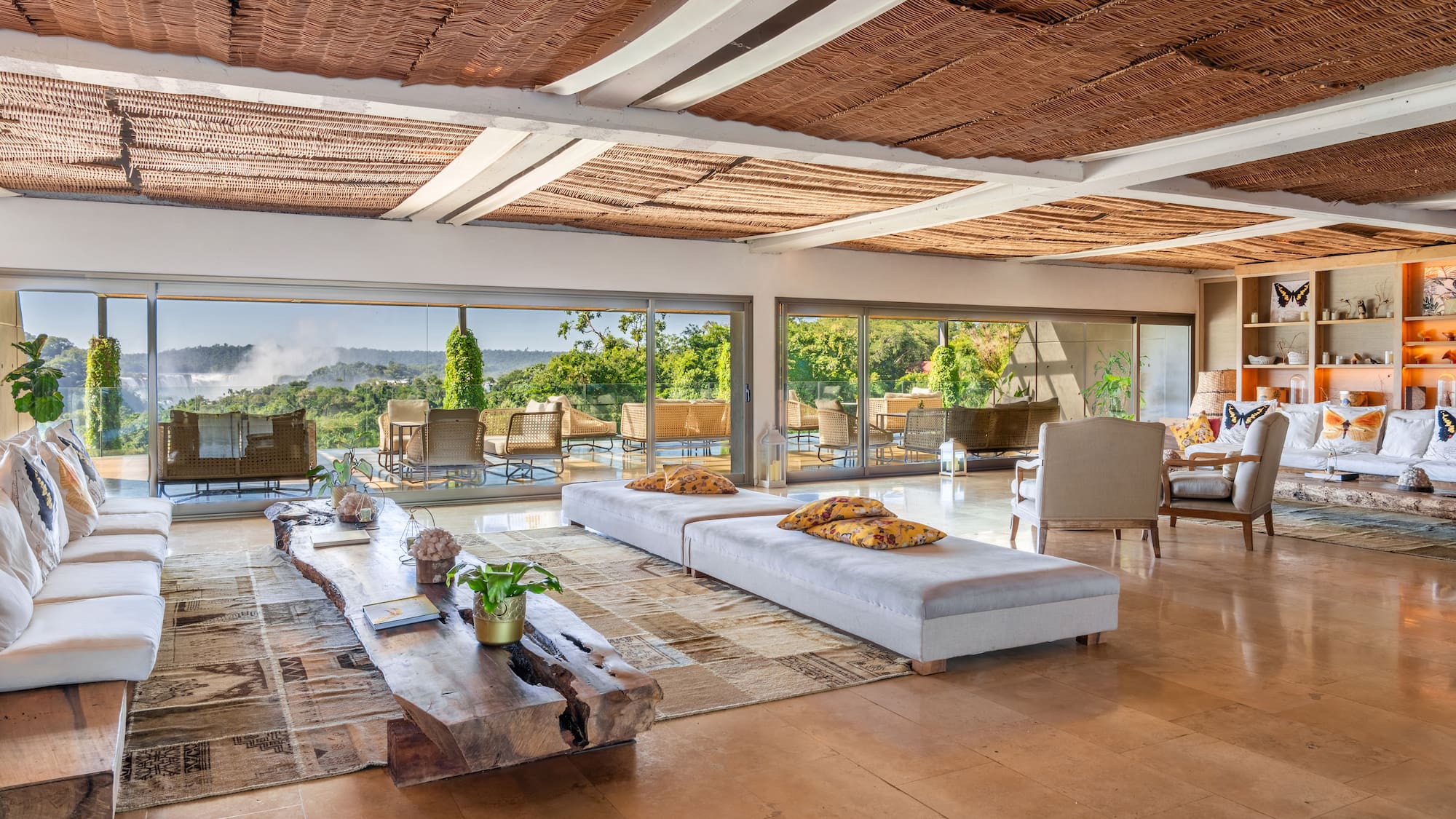 a large living room with a large table and chairs