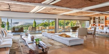 a large living room with a large table and chairs