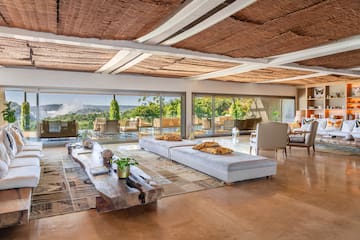 a large living room with a large table and chairs