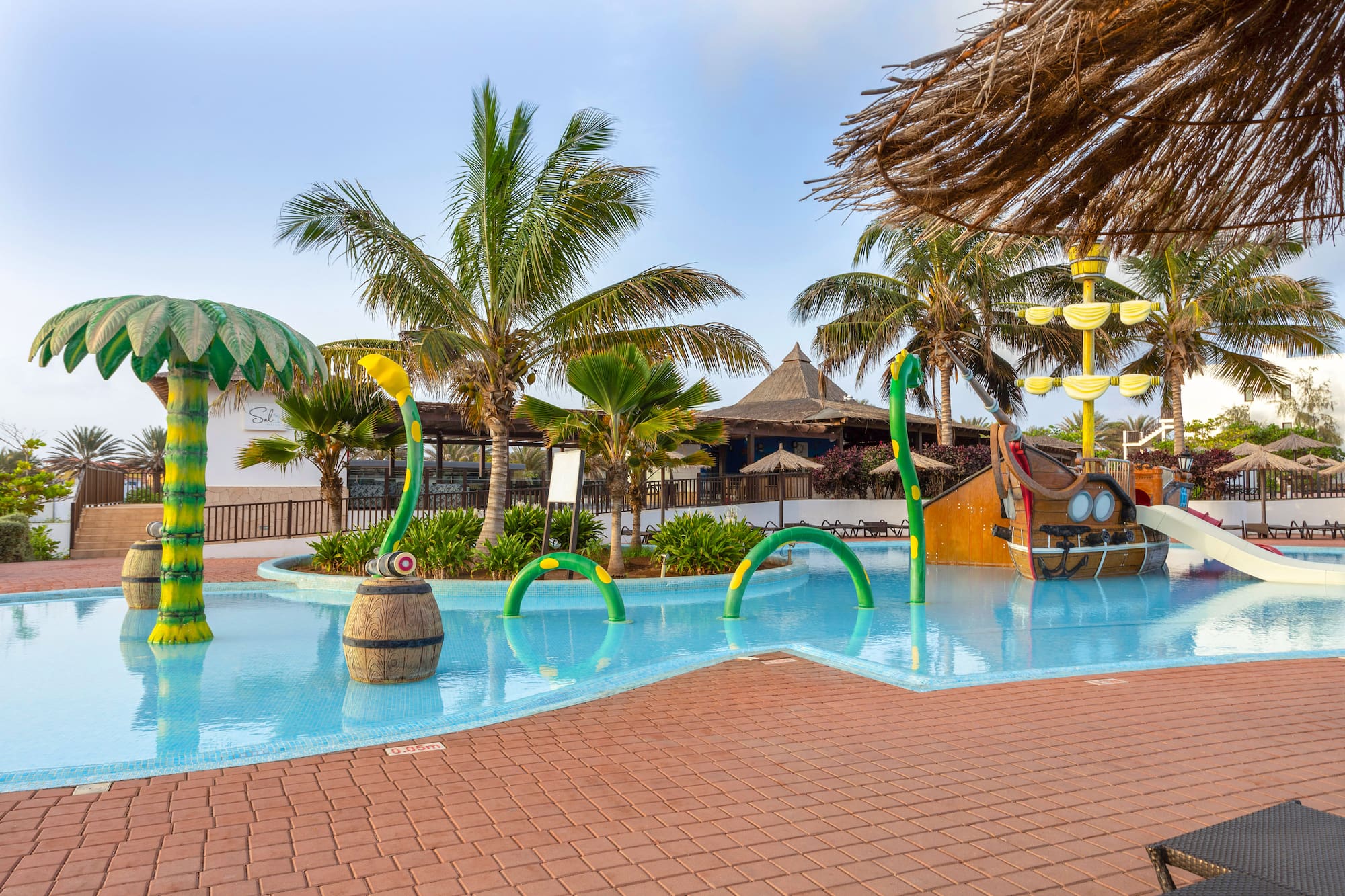a pool with a water slide and a boat