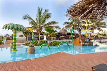 a pool with a water slide and a boat