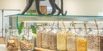 a shelf with jars of food and a statue of a monkey
