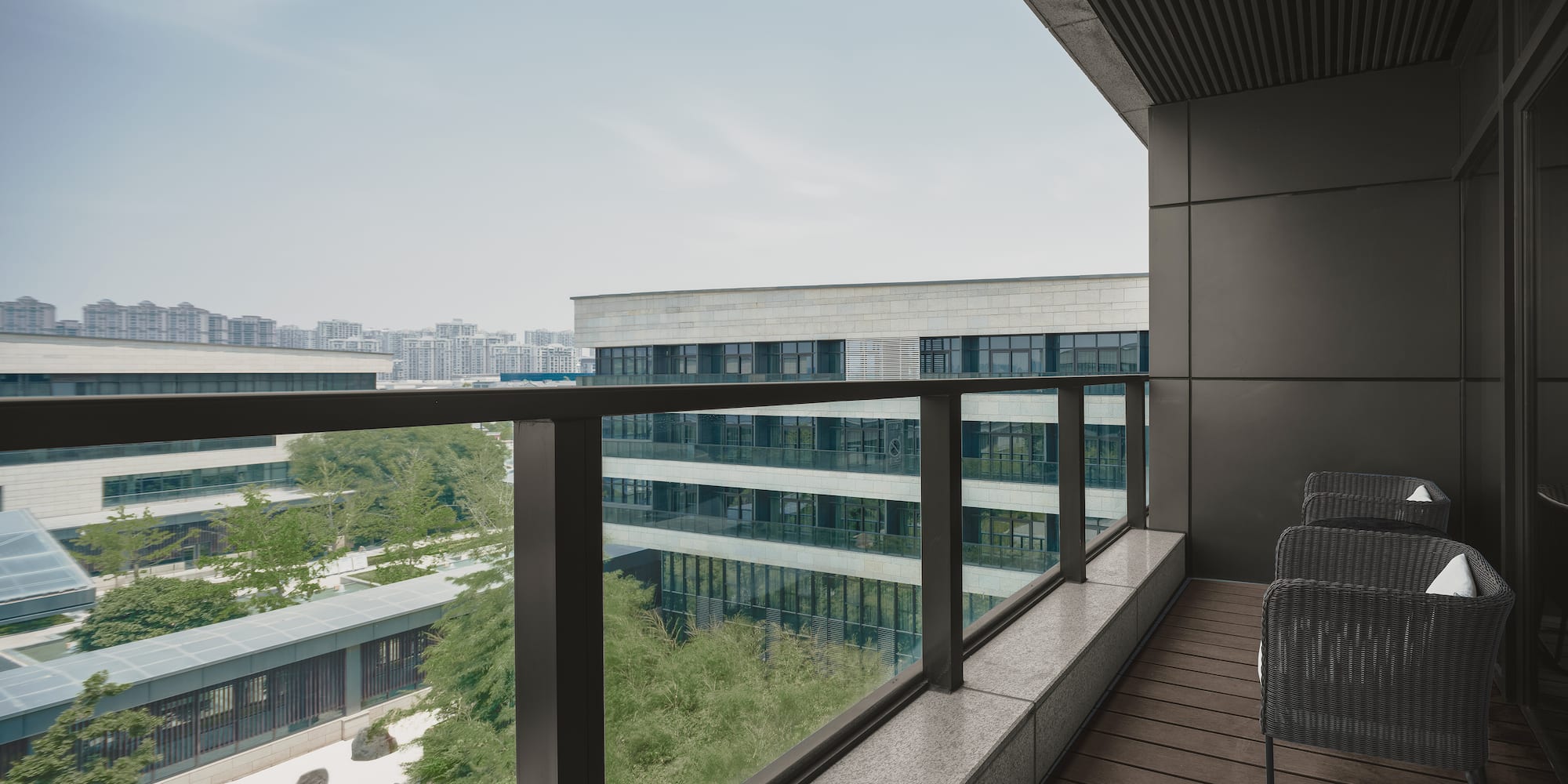 a balcony with chairs and a railing