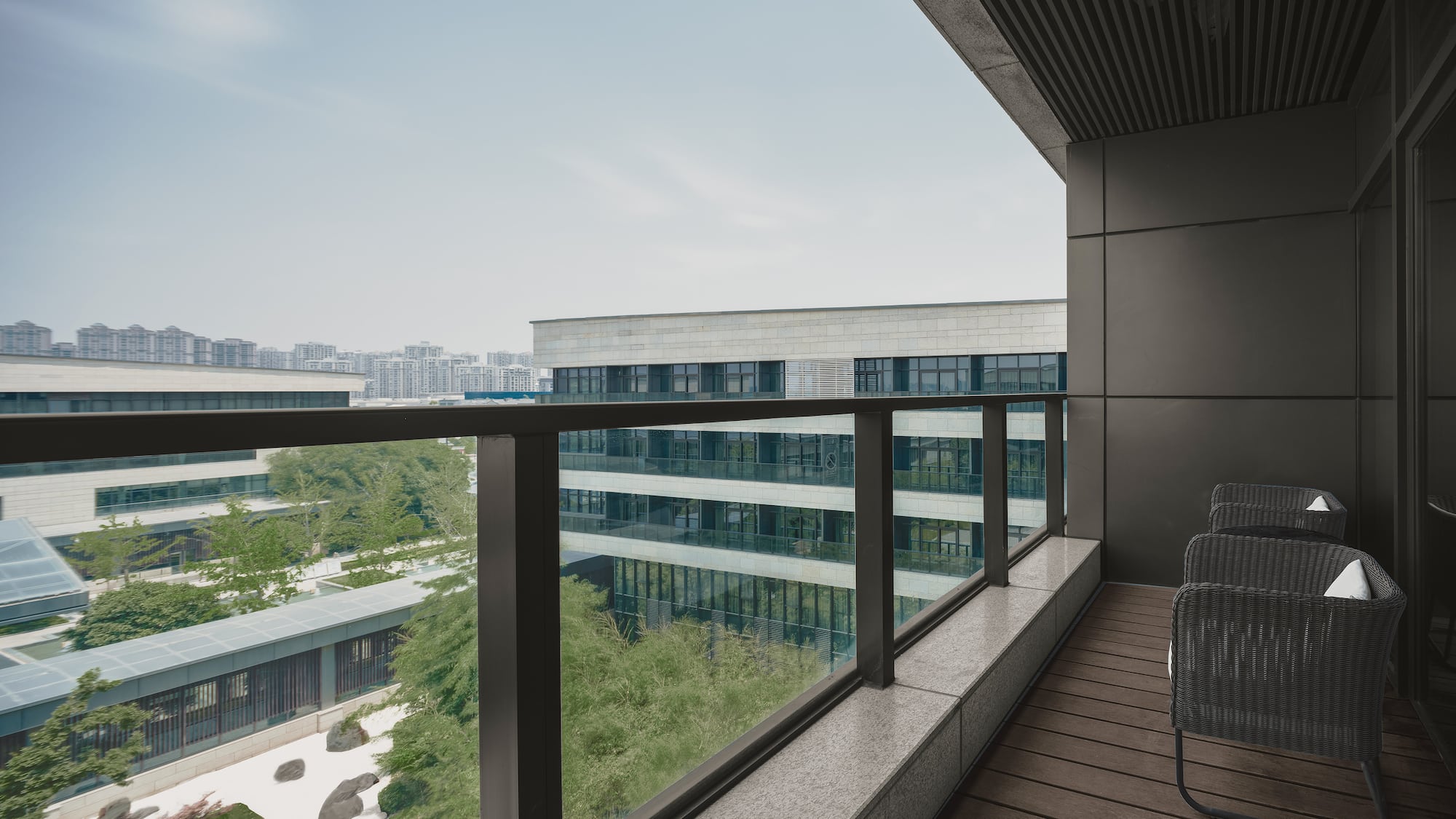 a balcony with chairs and a railing