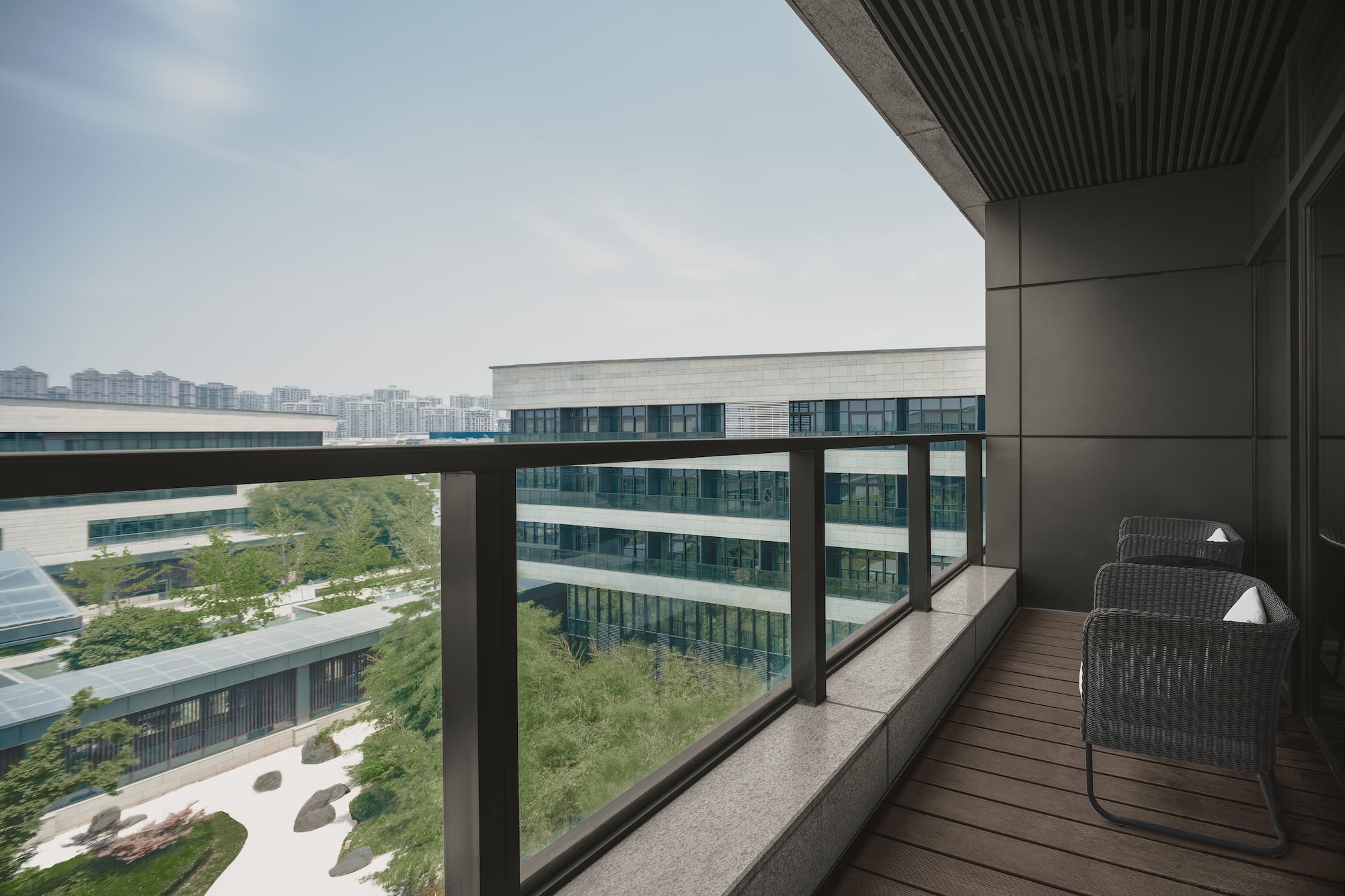 a balcony with chairs and a railing