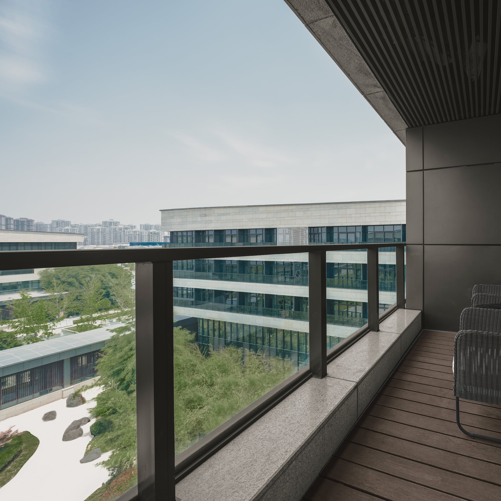 a balcony with chairs and a railing