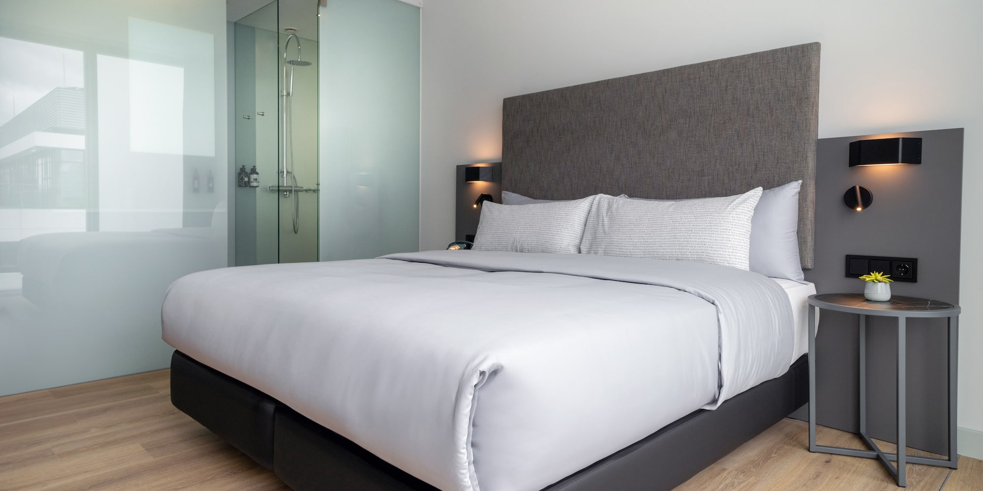 a bed with a glass shower