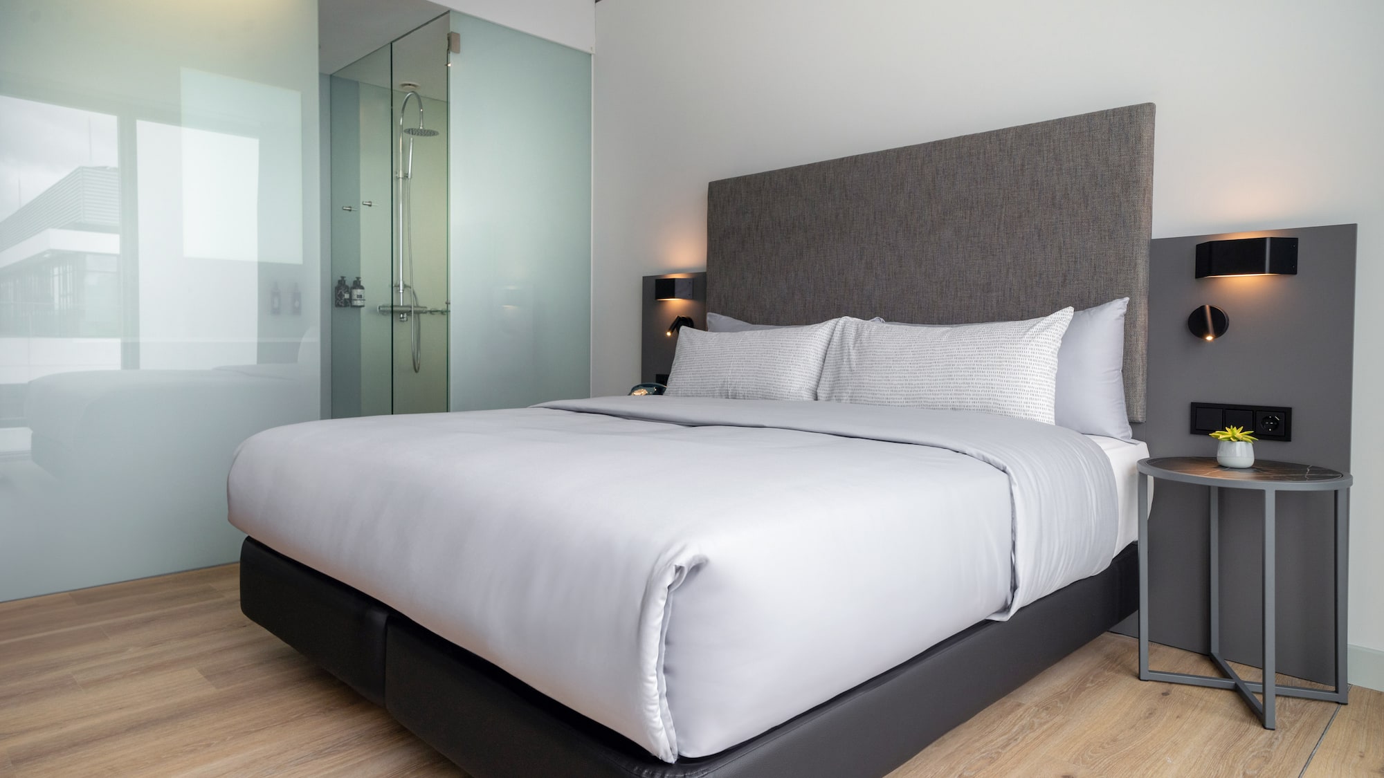 a bed with a glass shower