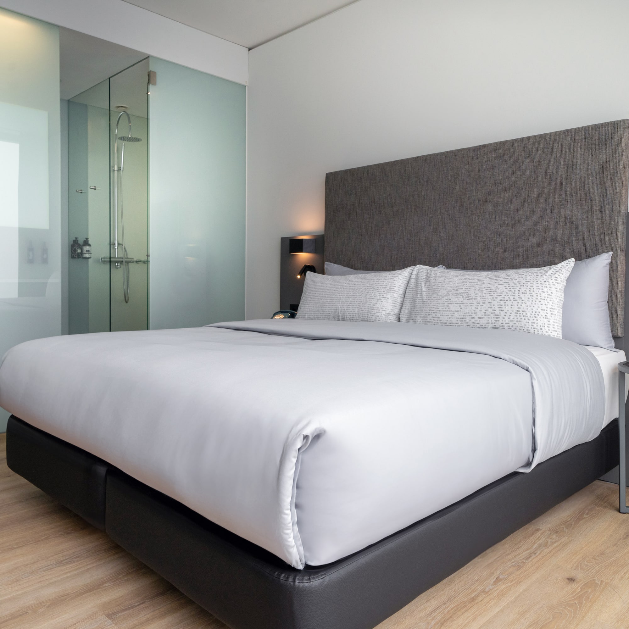 a bed with a glass shower