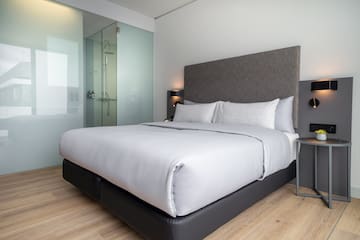 a bed with a glass shower