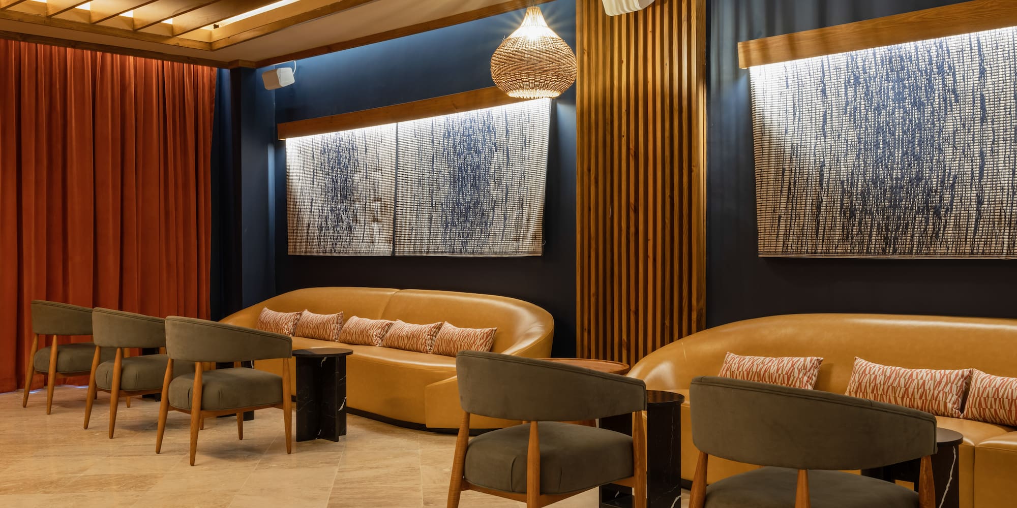 a room with a couch and chairs