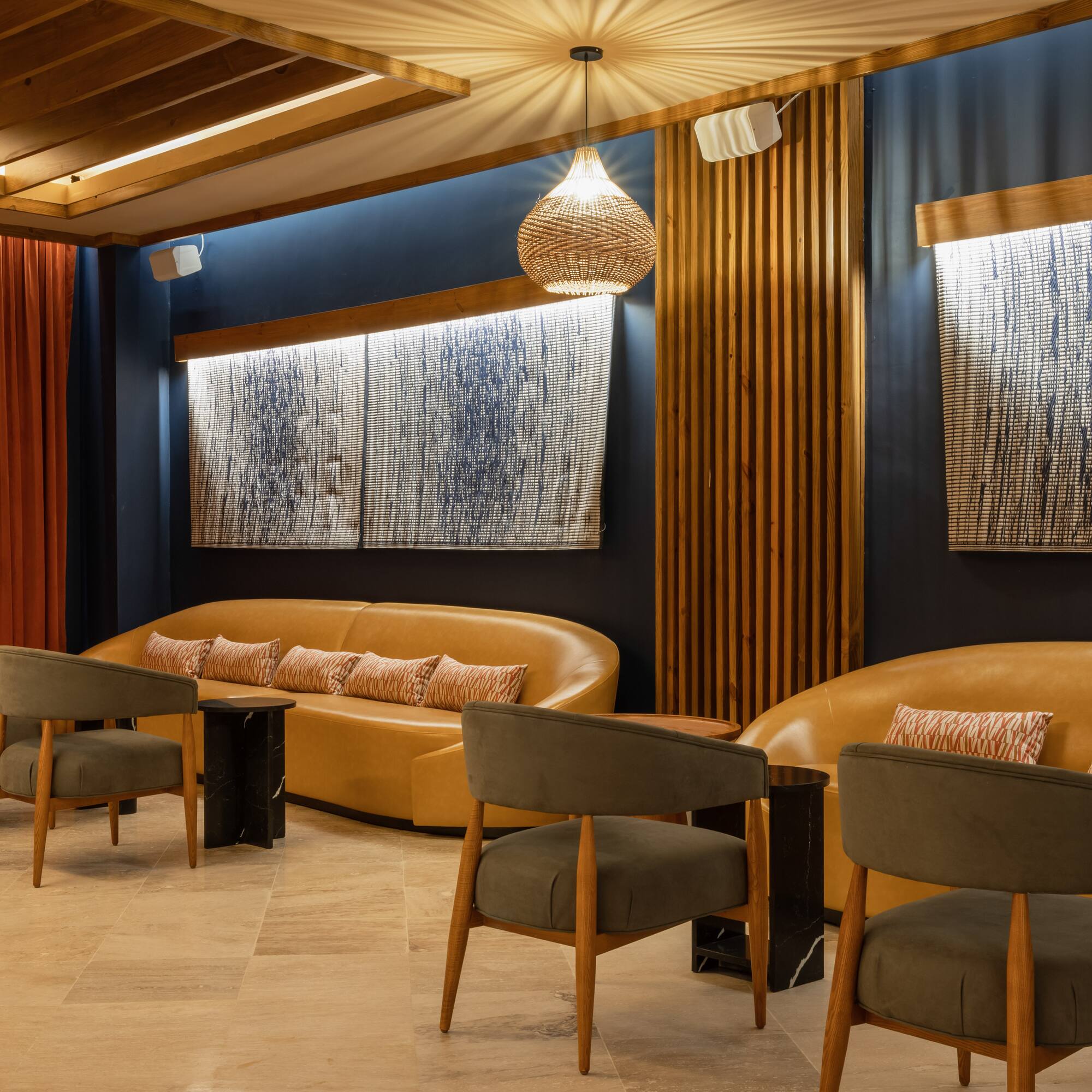 a room with a couch and chairs