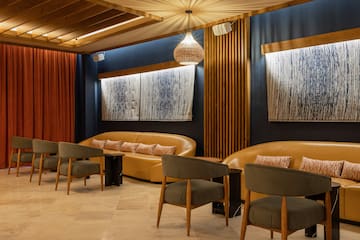 a room with a couch and chairs