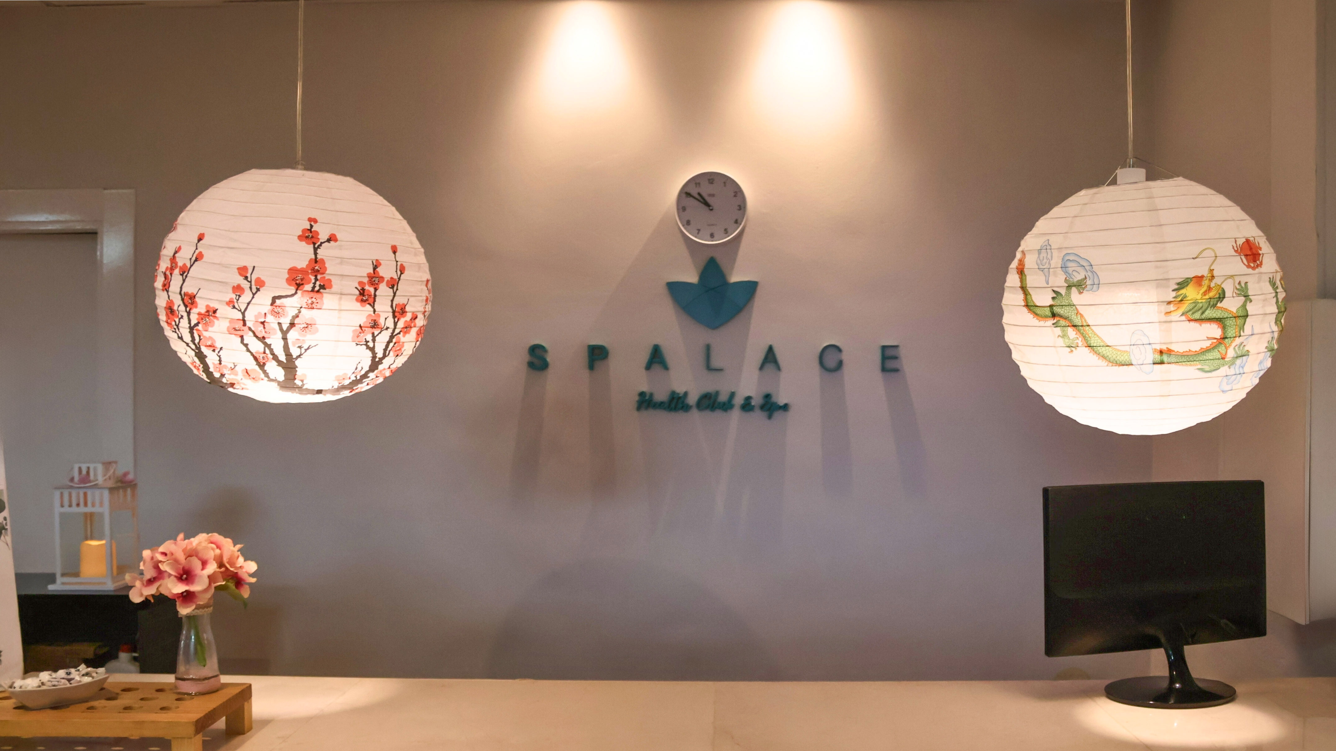 SPALACE Health Club & Spa reception with cherry blossom and dragon lanterns.