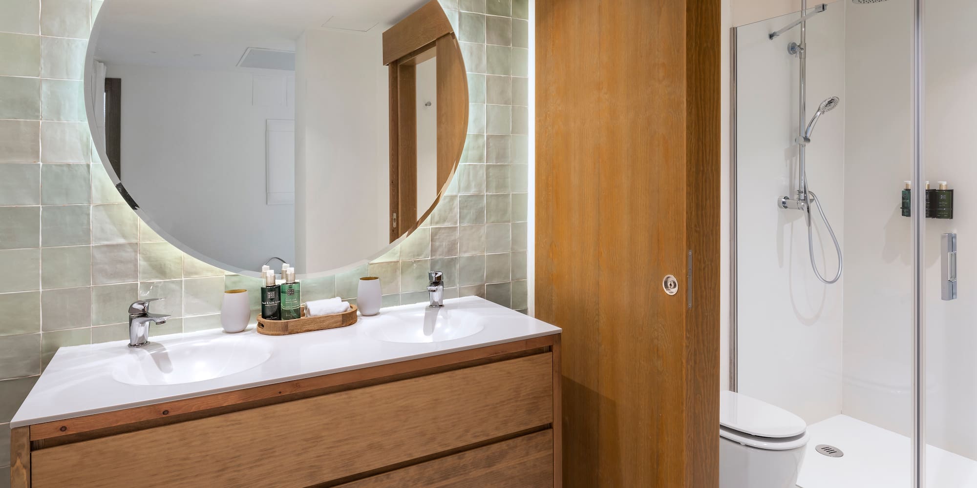 a bathroom with a round mirror