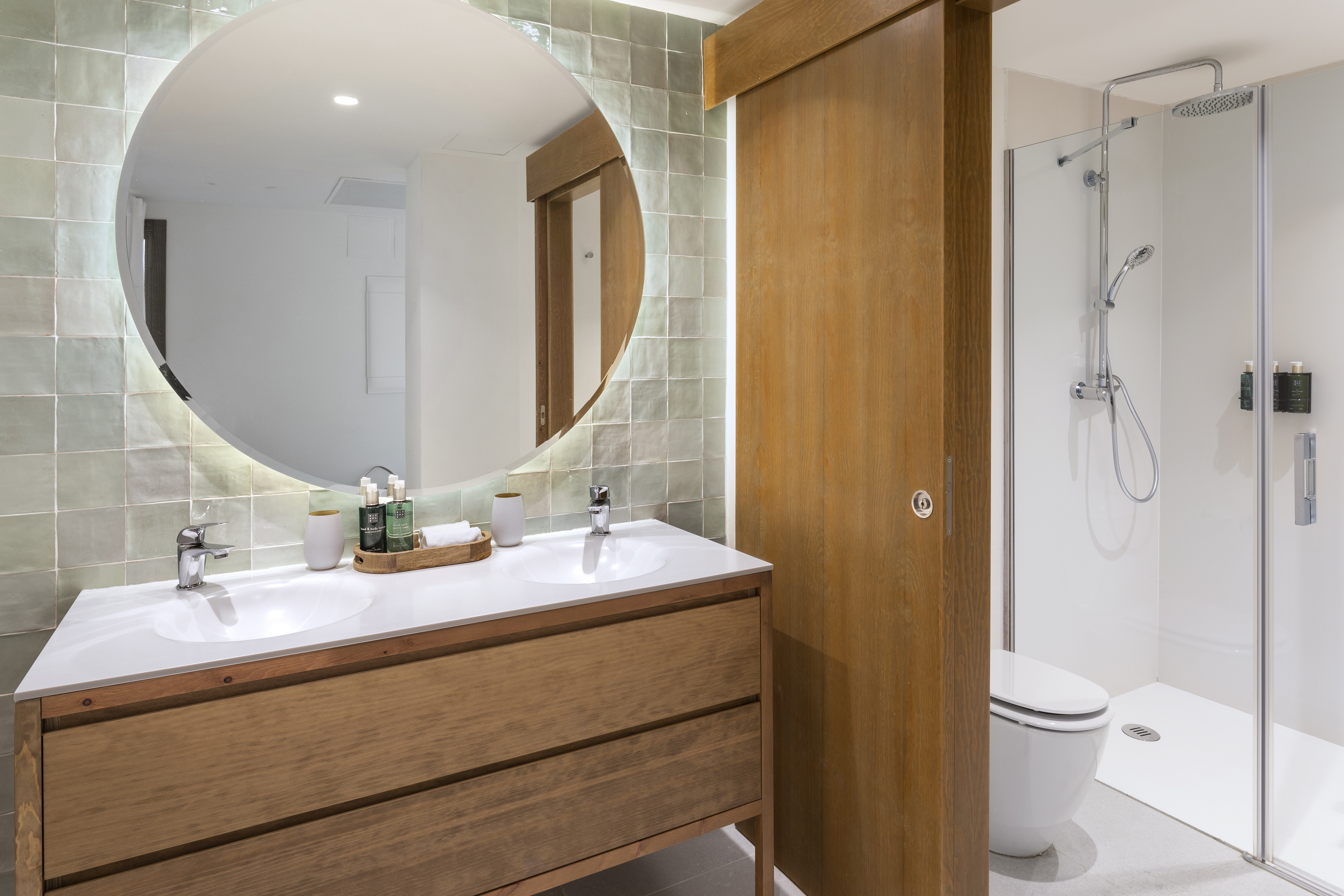 a bathroom with a round mirror
