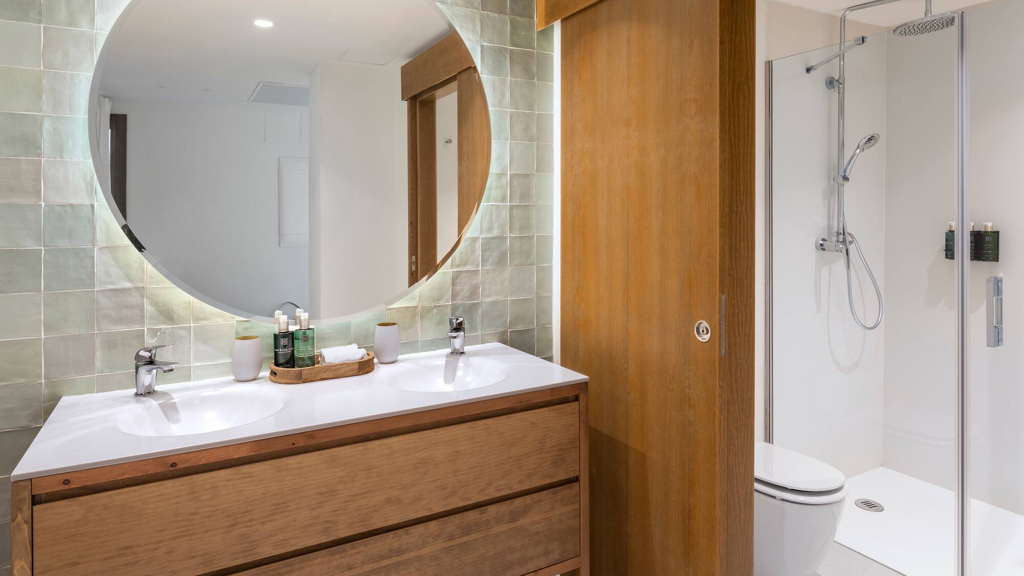 a bathroom with a round mirror
