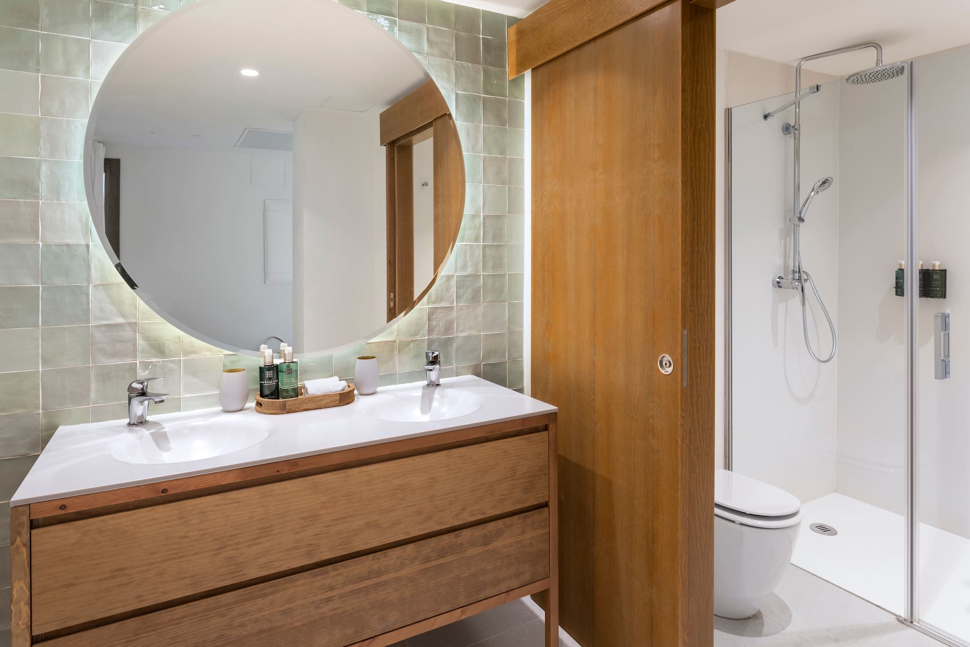 a bathroom with a round mirror