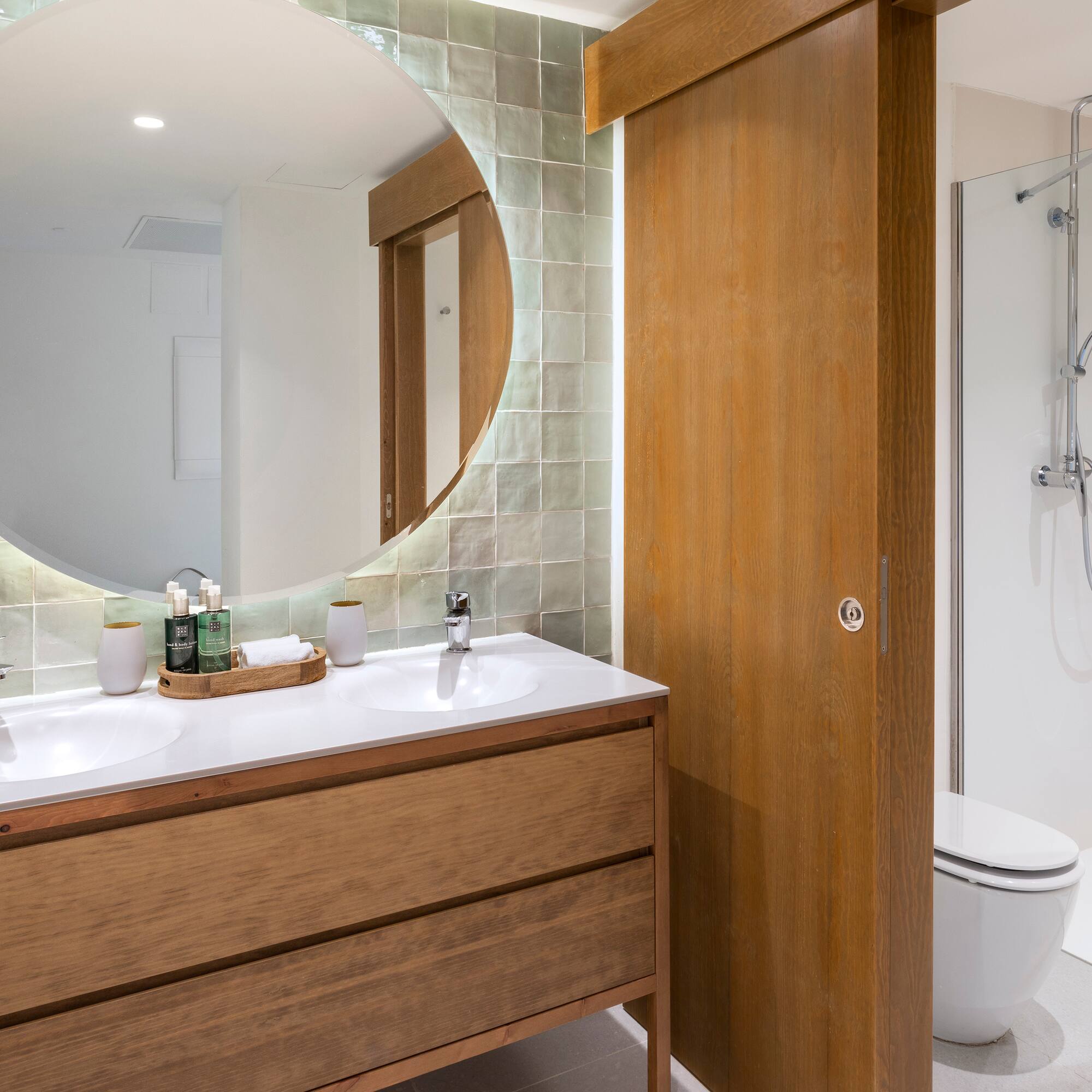 a bathroom with a round mirror