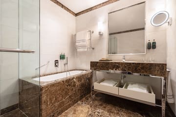 a bathroom with a bathtub and a mirror