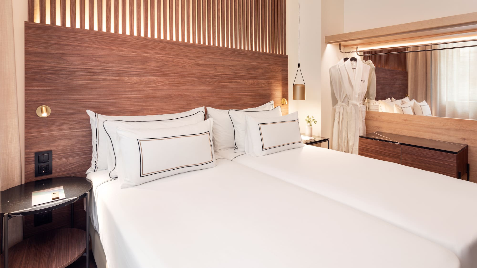 a bed with white sheets and a wooden headboard