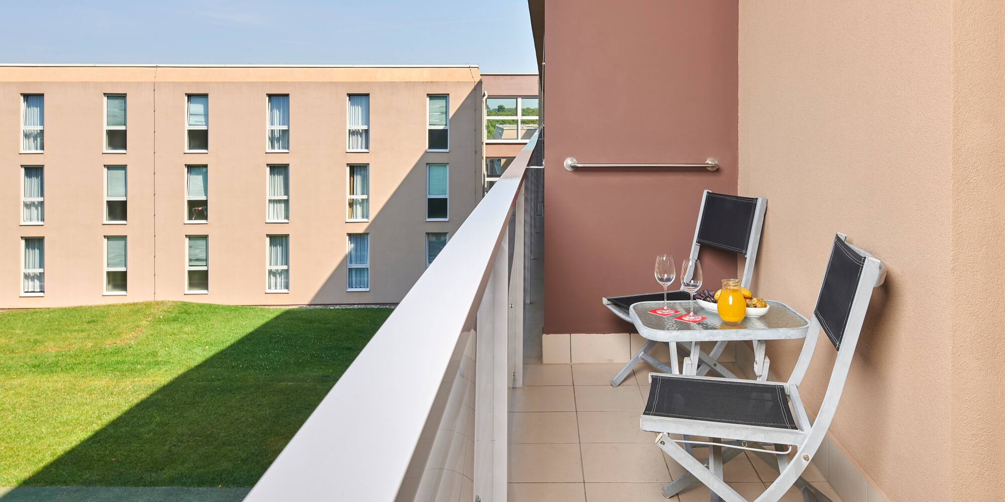 a balcony with chairs and table