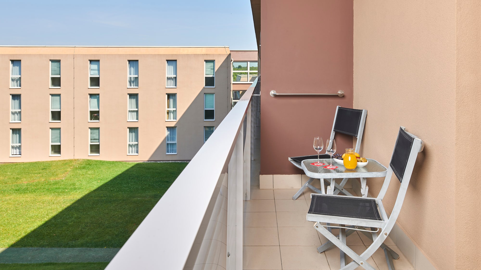 a balcony with chairs and table