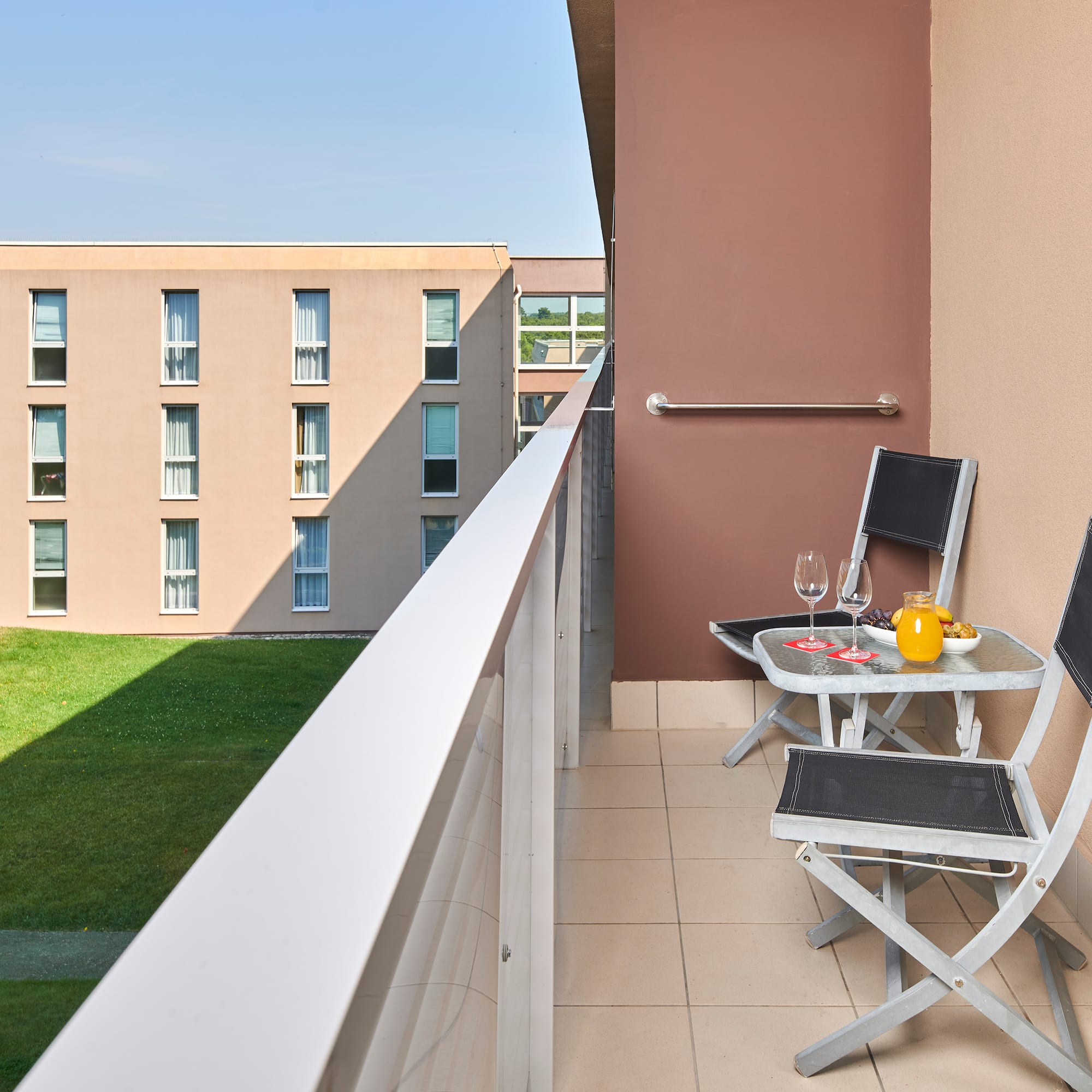 a balcony with chairs and table