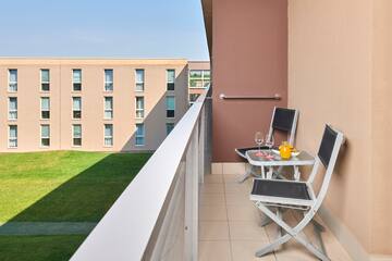 a balcony with chairs and table
