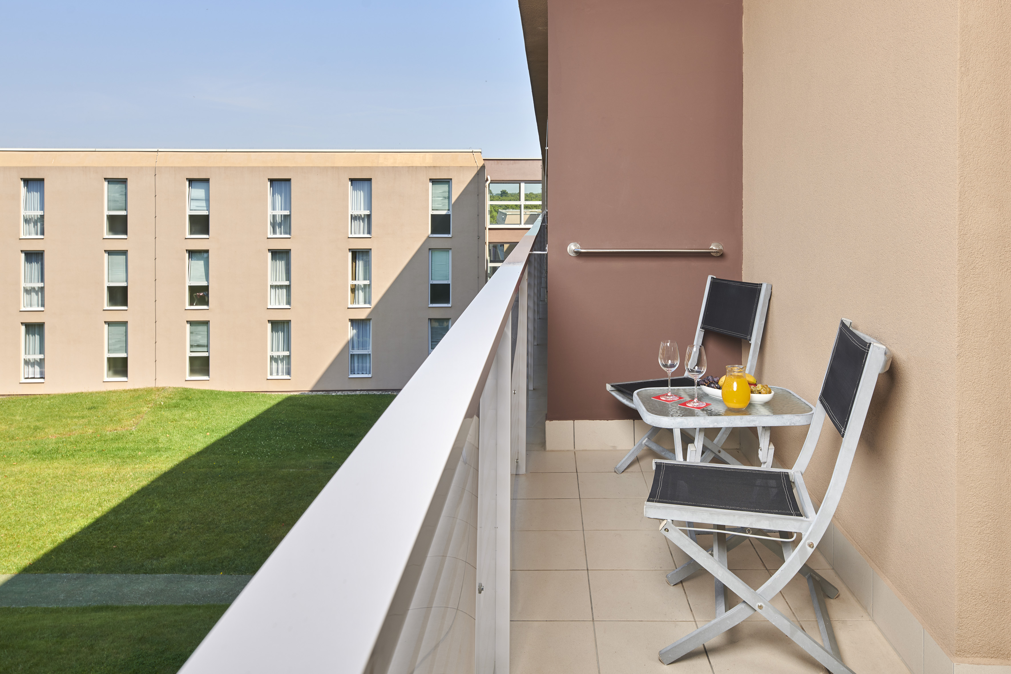 a balcony with chairs and table